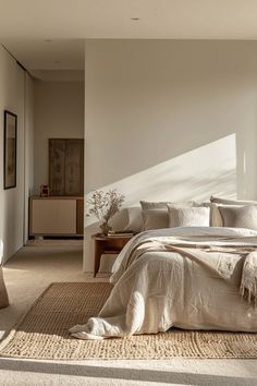 a large bed sitting in a bedroom on top of a rug next to a window