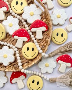 decorated cookies in the shape of smiley faces on a wicker basket next to other decorations