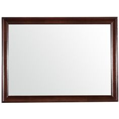 a brown framed mirror sitting on top of a white wall