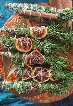 an arrangement of fruits and herbs on a plate