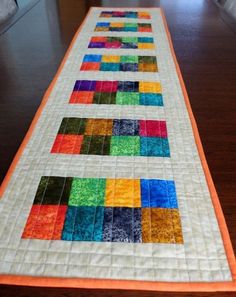 a long table runner made with colorful squares