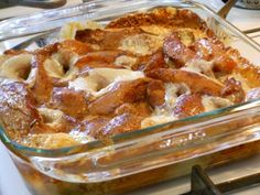 a glass casserole dish filled with food on top of a stove