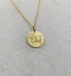 "Chef Necklace - Engraved Chef Charm - Gold Graduation Charm - Gold Cooking Pendant ▪️ A beautiful and clean engraved Chef pendant made out of 14K Solid Real Gold. Available only in yellow gold! Pendant Thickness: 0.65mm Jump Ring inner diameter: 4mm Dimensions - Small - 13x13mm / 0.51 x 0.51 inches Medium - 14x14mm / 0.55 x 0.55 inches Big - 15x15mm / 0.59 x 0.59 inches Necklace Length - You can choose your chain length from 35CM to 50CM. The pendant is available alone without a chain, select \ 14k Gold Jewelry With Hallmark For Personalized Gift, 14k Gold-tone Necklace For Gifts, Round Gold-tone 14k Gold Charm Necklace, Round 14k Gold-tone Charm Necklaces, Round 14k Gold-tone Charm Necklace, Engraved Yellow Gold Fine Charm Necklace, Polished 14k Gold Charm Necklace, Gold-tone Round Charm Necklaces For Gifts, Gold Charm Necklace With Polished Finish In 14k Gold