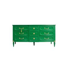 a green dresser with gold handles and drawers