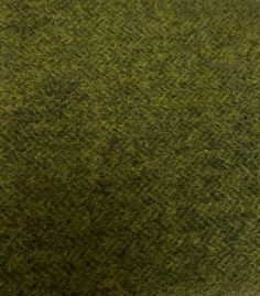 a close up view of the texture of a green carpet