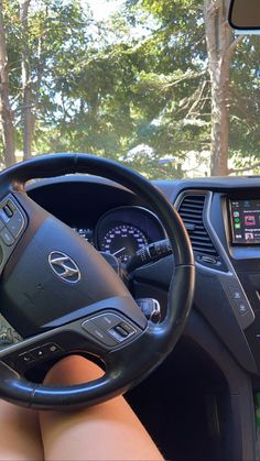 a woman is sitting in the driver's seat of a car with her feet on the steering wheel