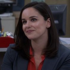 a woman sitting in an office chair with her arms crossed and looking off to the side