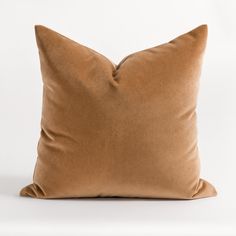 a brown pillow sitting on top of a white table