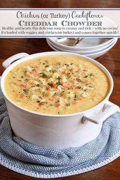 a white bowl filled with soup sitting on top of a table next to a plate