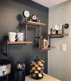 two shelves with coffee cups and other items on them in the corner of a room