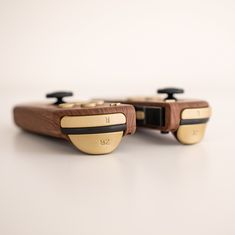 two wooden video game controllers sitting next to each other