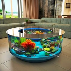 a fish tank is sitting in the middle of a living room with couches and tables