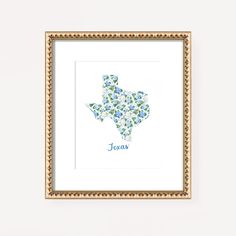 a framed art print with the shape of texas in blue and green flowers on it