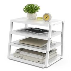 a white shelf with books and a clock on it's side, against a white background