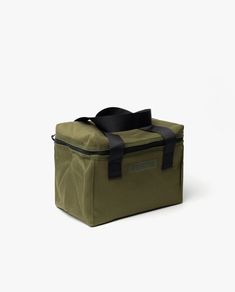 an olive green lunch bag with black straps on the front and side, sitting against a white background