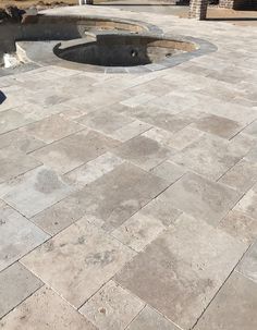 a fire hydrant sitting on the side of a road next to a cement slab