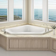 a large white bath tub sitting next to two windows