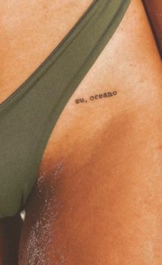 a close up of a person's stomach with the word e, ocean written on it