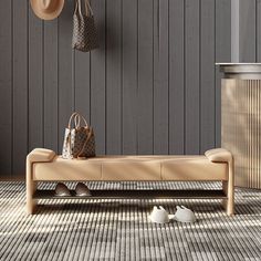 a wooden bench sitting on top of a floor next to a purse and two hats