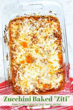 a casserole dish with cheese and meat in it on a red and white checkered cloth