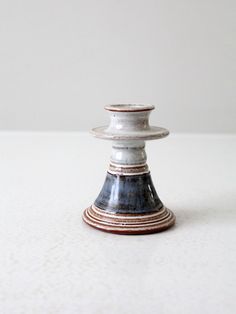 a white and blue vase sitting on top of a table