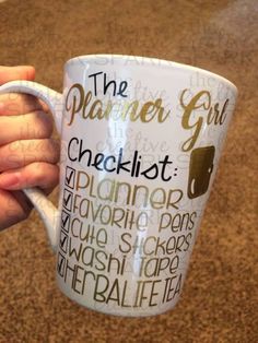 a person holding a coffee cup with the words planner girl written on it in different languages