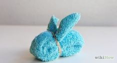 a small blue stuffed animal sitting on top of a table