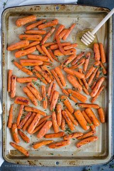 roasted carrots on a baking sheet with honey butter