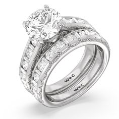 an engagement ring set with two bands and a center stone in the center, on top of