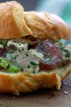 a close up of a sandwich with meat and veggies on it's side