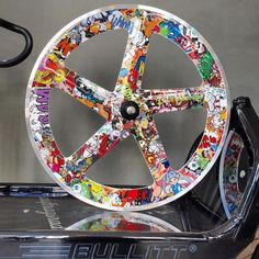 a wheel with comic stickers all over it