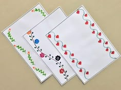 three pieces of paper with hearts and flowers on them, sitting next to each other