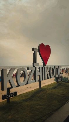 a sign that says i love kozhikod on the beach