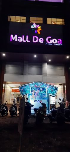 motorcycles parked in front of a building with the word mall de goa on it's side