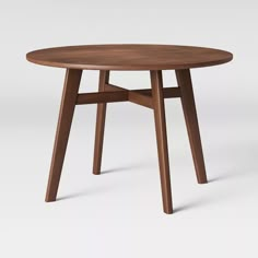 a round wooden table with two legs on the top and one leg extended to the side