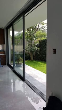 an empty room with large sliding glass doors