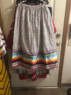 a colorful skirt hanging on a door