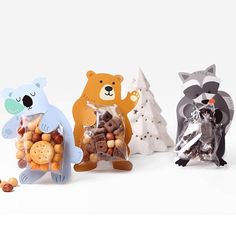 three different types of animals are shown in this photo, one is holding a bag of cookies and the other has an animal figurine