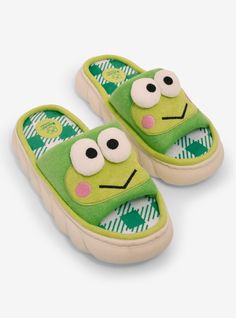 a pair of green slippers with eyes on them