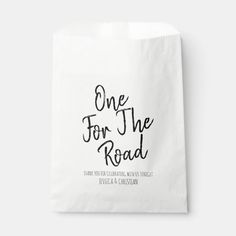 a white paper bag with the words one for the road printed on it and black lettering