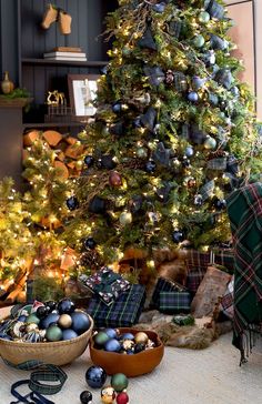 the christmas tree is decorated with plaid and ornaments