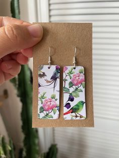 Beautiful handmade earrings featuring pink roses & birds 🦜 made from recycled biscuit tins they're sustainably sourced & very lightweight! - 925 silver plated steel hooks - Size: 2x4.5cm Check out more of my earrings here: https://gracenicolexx.etsy.com **Please note that all of my items are handmade from recycled materials so please allow for small imperfections and slight variations in patterns & size** Tin Earrings, Paper Earrings, Wild Birds, Handmade Earrings, Recycled Materials, Pink Roses, Jewelry Earrings Dangle, 925 Silver, Silver Plated