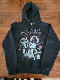 a star wars hoodie sitting on top of a wooden floor