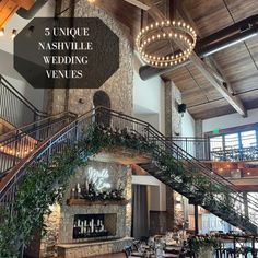 the inside of a restaurant with tables, chairs and stairs leading up to an indoor fireplace