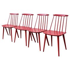 four red chairs sitting next to each other