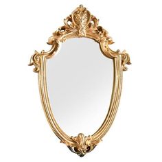 an ornate gold framed mirror against a white background