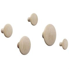 three wooden knobs are shown on a white background