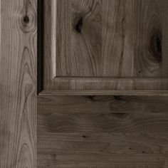 a close up view of the wood grains on this cabinet door and its handle