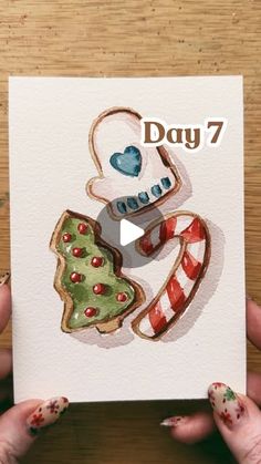 two hands holding up a card with the words day 7 on it and an image of a