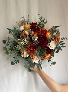 a bouquet of flowers is being held by someone